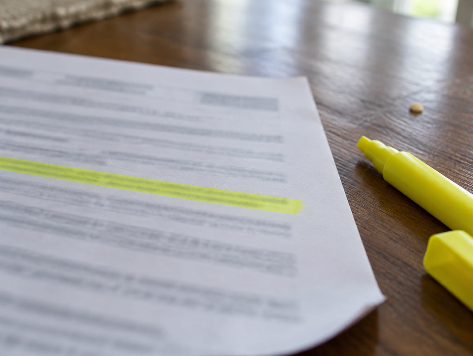 Homeowner's finger on the policy dates of a printed certificate of insurance
