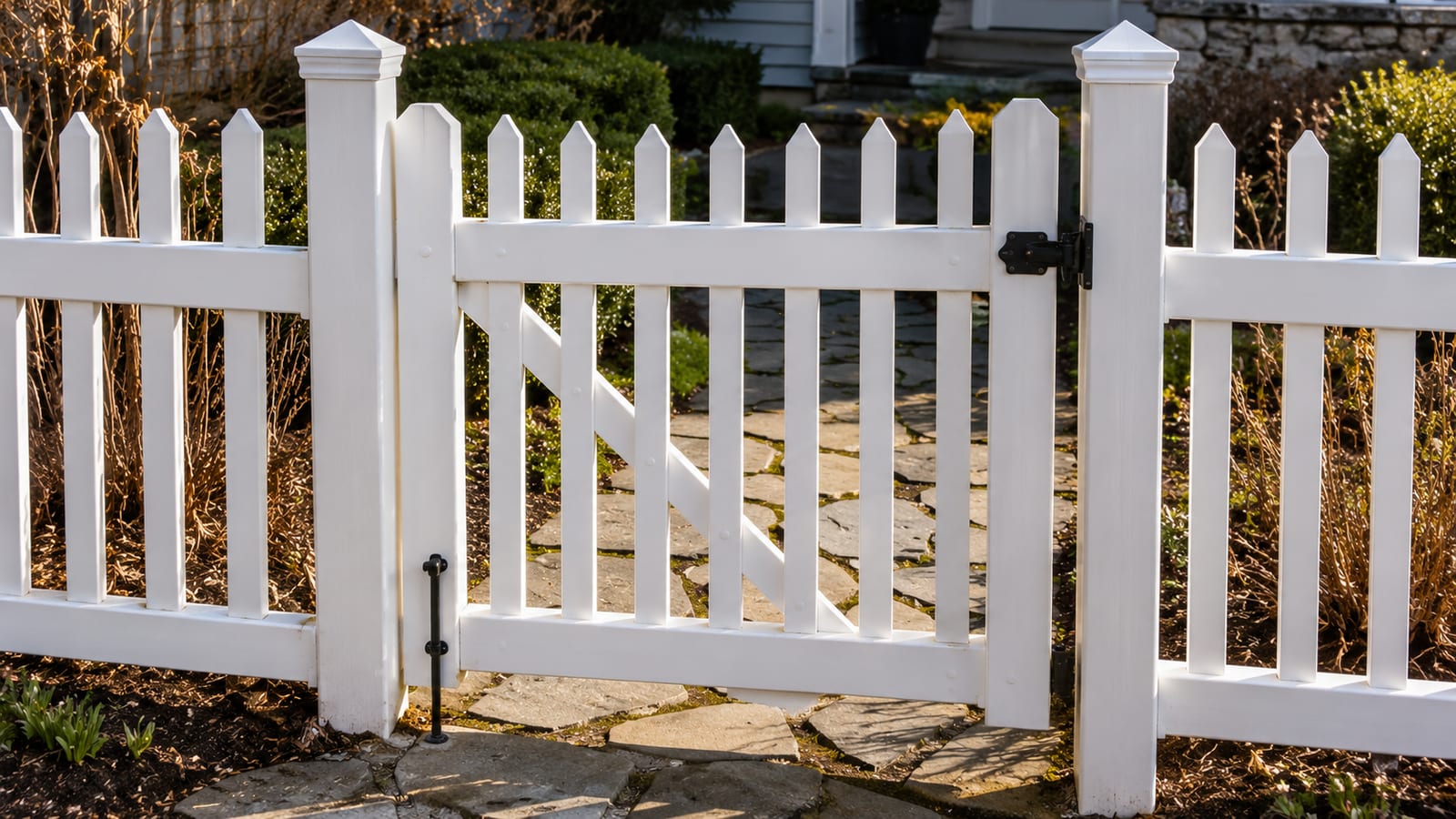 Vinyl fence posts set plumb in concrete footings along a marked fence line