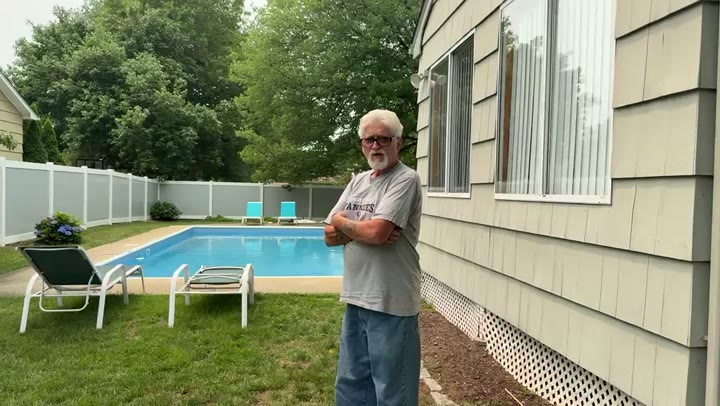 Finished white vinyl privacy fence enclosing an in-ground pool