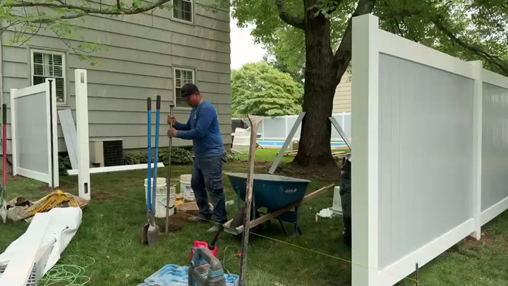 Setting posts for a white vinyl privacy fence